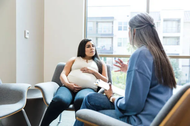 Pregnant woman meeting with a pregnancy resource center counselor
